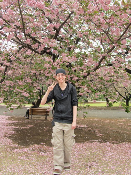 KCP student Steven under a lush sakura tree.
