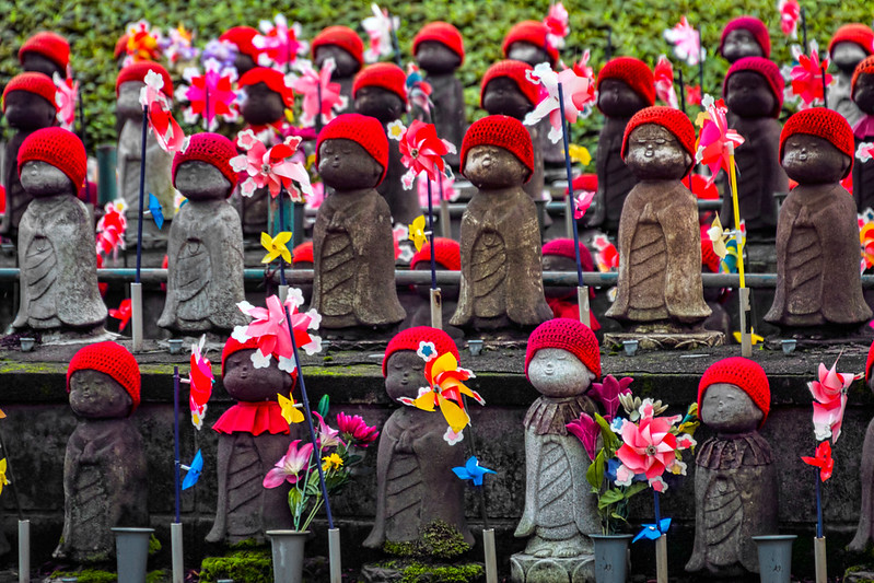 Jizo Bosatsu Statues with Red Bibs, Hats, and Fans