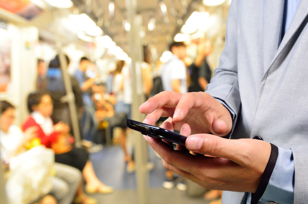 Business,Man,Using,Mobile,Phone,In,Train,Or,Subway