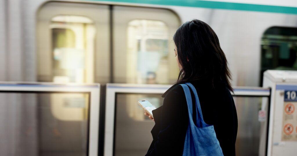 person standiing in front of subway train doors